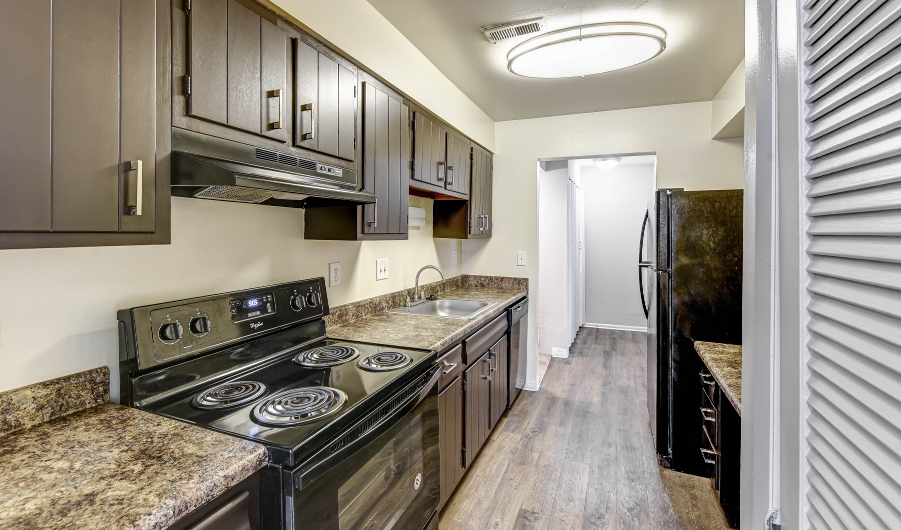 Find your apartment in Dayton, Ohio Galley kitchen with brown cabinets